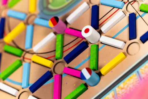 Colorful wooden puzzle with interlocking pieces on a wooden board