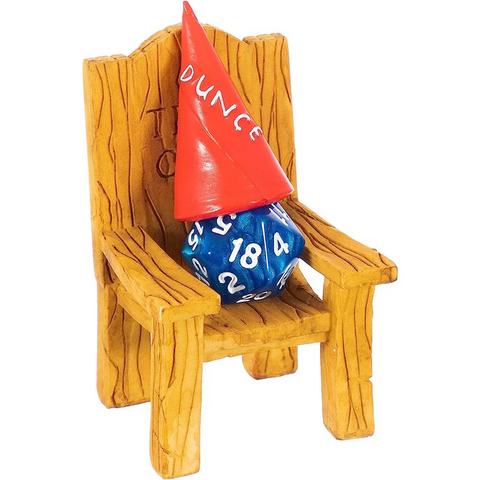 Red dunce cap on a blue die sitting on a wooden chair with a white background