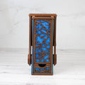 Wooden side table with blue decorative panel on a white background