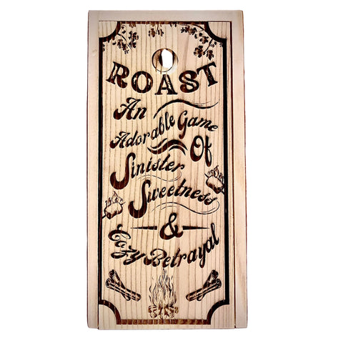 Wooden sign with engraved text and decorative elements on a wooden surface