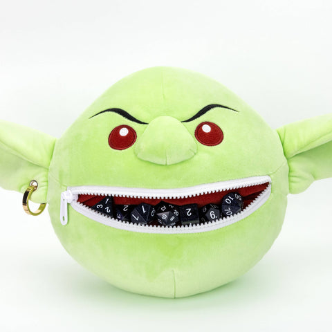 Green plush toy with a zipper mouth on a white background