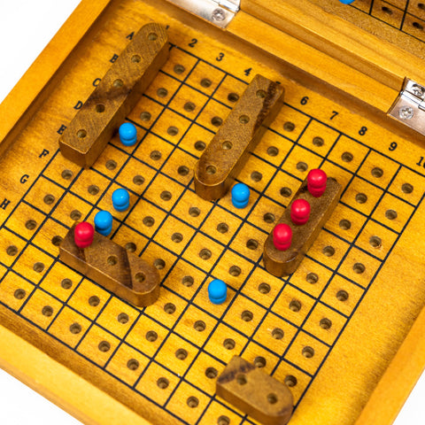 Wooden game board with pegs and a grid pattern