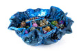 Blue dice bag filled with multicolored dice on a white background