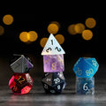 Colorful polyhedral dice on a dark background with blurred lights