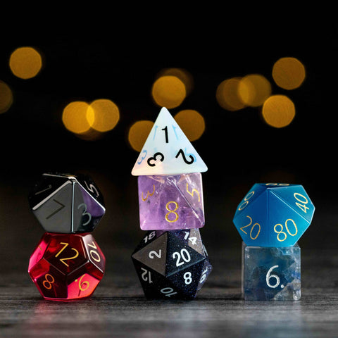 Colorful polyhedral dice on a dark background with blurred lights