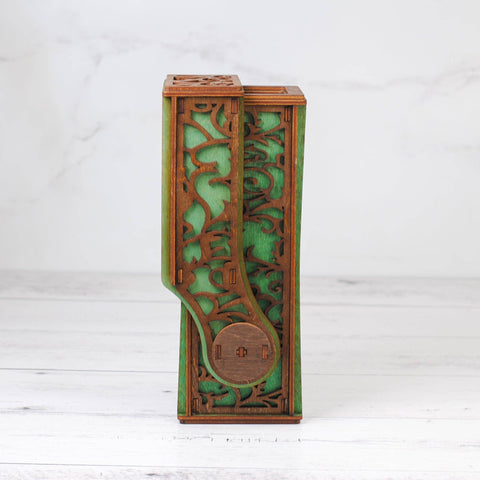 Decorative wooden box with green accents on a white background