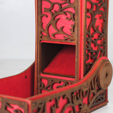 Wooden shelf with red interior and intricate carvings on a white background