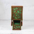 Decorative wooden box with intricate carvings on a white background