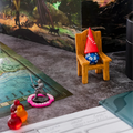 Miniature game chair with dice and figurines on a fantasy-themed board game setup