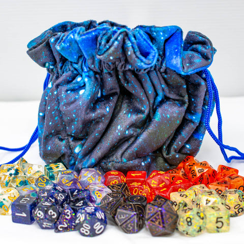 Blue drawstring bag with assorted dice on a white background