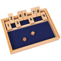 Wooden dice game with numbered blocks and two dice on a blue mat