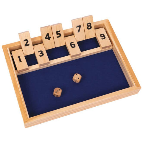 Wooden dice game with numbered blocks and two dice on a blue mat
