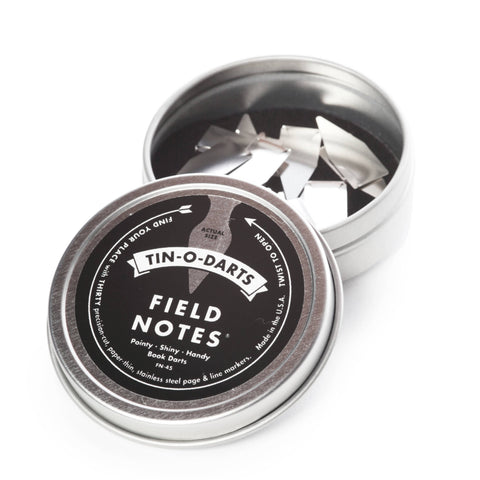 Tin of Field Notes with darts on a white background