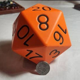 Orange polyhedral dice with black numbers on a white surface