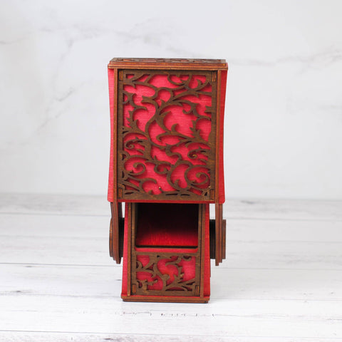 Decorative wooden box with red pattern on a white background