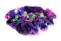 Purple velvet dice bag filled with multicolored dice on a white background