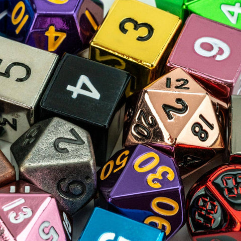 Assorted colorful dice with various numbers and lettering on a dark background