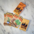 Card game packaging with cards on a marble surface