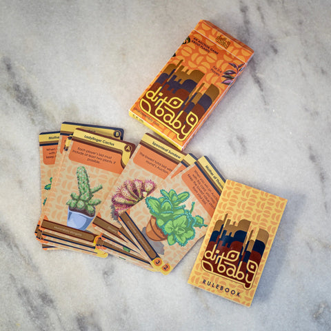Card game packaging with cards on a marble surface