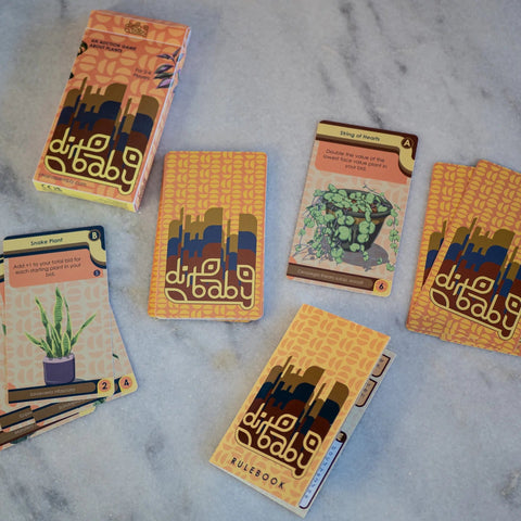 Collection of 'dirt baby' roleplaying game books on a marble surface