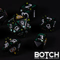 Set of black dice with white numbers on a dark background, featuring the brand 'BOTCH'.