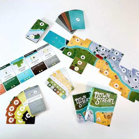 Board game components including cards and a map on a white background