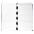 White notebook with black spiral binding on a white background