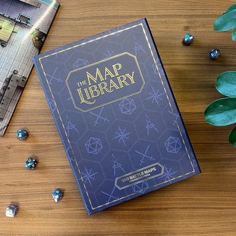 Blue book titled 'The Map Library' on a wooden surface with dice and a map.