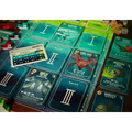 Board game cards with various illustrations and text on a wooden surface