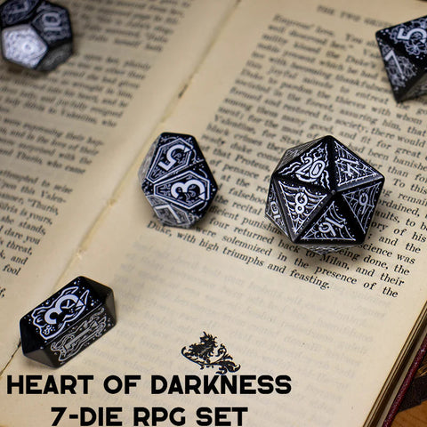 Black and white dice set on an open book with 'Heart of Darkness' text, featuring the BOTCH brand.