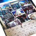 A close-up of a collage-style calendar or planner page with pinned photos, red string connections, and a numbered grid at the bottom, photographed on a white background.