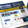 A printed game instruction sheet titled 'Detective: A Modern Crime Game Season One' is shown on a white surface, with part of its blue retail box visible at the right edge. The sheet includes component lists, character cards, and setup instructions.