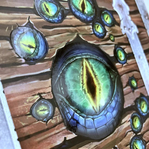 Close-up of a detailed monster eye illustration on a wooden background