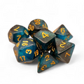 Set of polyhedral dice with blue and bronze glittery finish on a white background