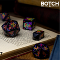 Colorful dice set on an open book with 'BOTCH' branding.