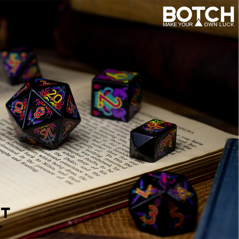 Colorful dice set on an open book with 'BOTCH' branding.