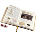 An open vintage-style book with cutout pages reveals hidden illustrations and text, shown alongside a printed character card and two red dice on a white background.