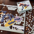 Jigsaw puzzle of the Great Lakes Basin on a wooden surface with packaging.
