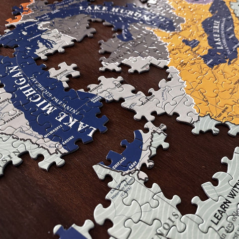 Jigsaw puzzle pieces with a map design on a wooden surface