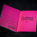 Open book with pink cover and black text on a dark background