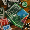 Collection of game cards and dice on a wooden surface