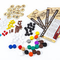 Assorted game pieces and rule books on a white background