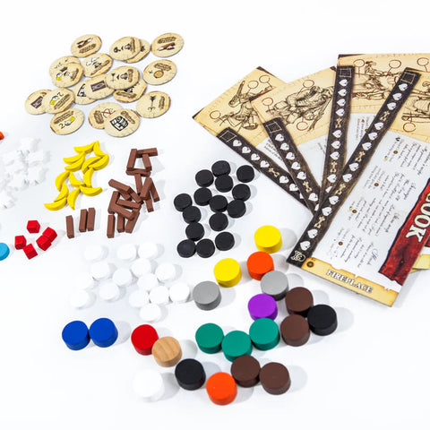 Assorted game pieces and rule books on a white background