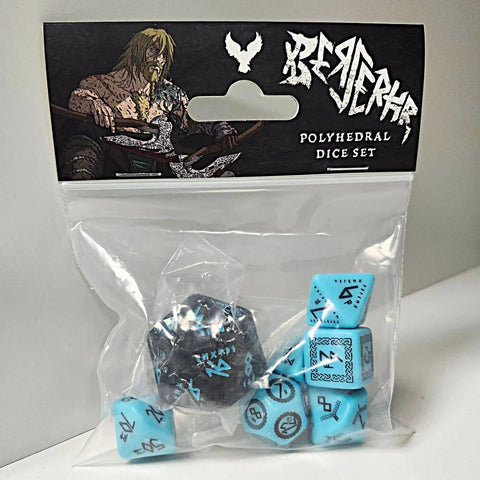 Set of blue dice with black markings in a clear plastic bag, branded 'Bejeweled'.
