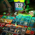 Board game 'Deep Regrets' with cards and pieces on a table