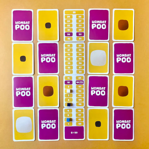 Collection of 'Wombat Poo' cards on a wooden surface