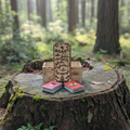 Wooden box with a decorative label on a tree stump in a forest
