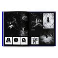 Open book displaying black and white photographs of nature and figures in a forest setting.