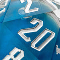 Close-up of a blue polyhedral dice with silver numbers