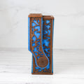 Decorative wooden vase with blue interior on a white background